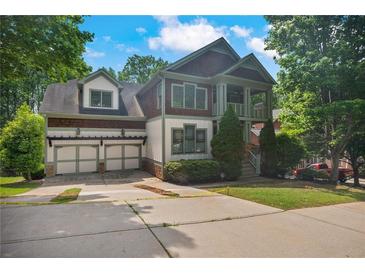 Charming two-story home with a two-car garage and a welcoming front porch in a lush, green neighborhood setting at 2548 Kickerillo Se Way, Atlanta, GA 30316
