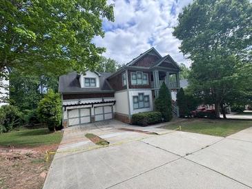 Charming two-story home with a two-car garage and mature trees at 2584 Kickerillo Se Way, Atlanta, GA 30316