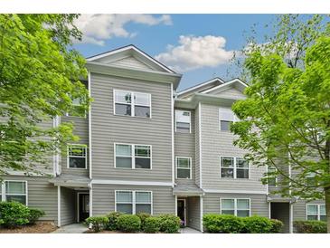 View of modern townhouse with gray siding, white trim, and well-maintained landscaping at 1365 Memorial Se Dr # 12, Atlanta, GA 30317