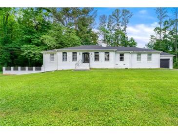 Charming home with a well-manicured lawn and inviting curb appeal at 4265 Hidden Valley Dr, South Fulton, GA 30349