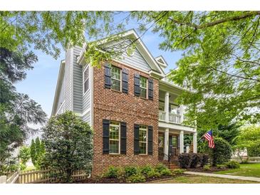 Charming two-story home featuring a brick facade, inviting front porch, and well-maintained landscaping at 3087 Dunton Se St, Smyrna, GA 30080
