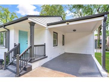 Charming home exterior featuring a light blue front door and covered parking area at 1398 Woodland Ave, Atlanta, GA 30316