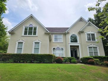 Elegant two-story home featuring a well-manicured lawn and symmetrical window placement at 365 Autumn Breeze Dr, Roswell, GA 30075