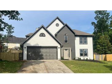 Charming two-story home with gray accents, a spacious two-car garage, and a well-manicured lawn at 1172 Rockmart Nw Cir, Kennesaw, GA 30144