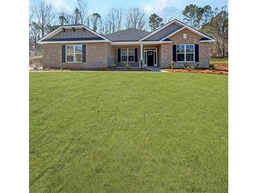 Charming one-story brick home with a well-manicured lawn and classic black shutters at 5301 Tuscany Dr, Douglasville, GA 30135