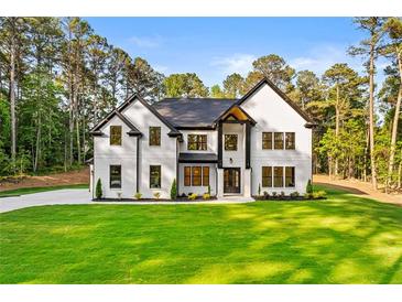 Beautiful two-story home with a brick facade, black accents, and a well-manicured lawn at 400 Auburn Rd, Auburn, GA 30011