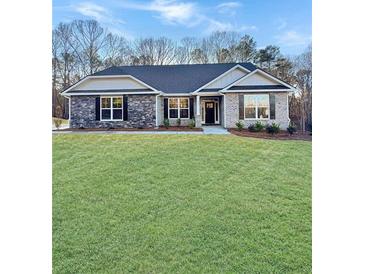 Charming single-story home with stone accents and a well-manicured lawn at 5331 Tuscany Dr, Douglasville, GA 30135