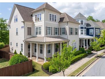 Charming two-story home with a covered front porch and manicured landscaping at 1085 Celebration Dr, Roswell, GA 30076