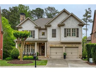 Charming two-story home with brick and shake siding, attached two-car garage, and well-manicured lawn at 4674 Lakeway Pl, Alpharetta, GA 30005
