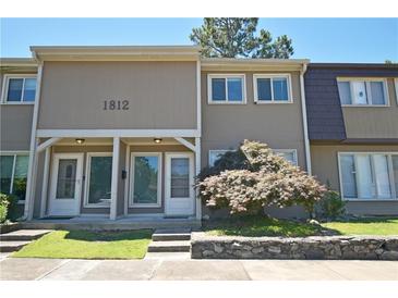 Charming townhome featuring a well-maintained front yard and neutral-toned exterior at 1812 Ashborough Se Cir # C, Marietta, GA 30067