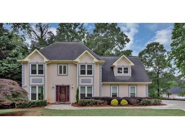 Charming two-story home with landscaped yard and inviting curb appeal on a treed lot at 509 Orchards Walk, Stone Mountain, GA 30087