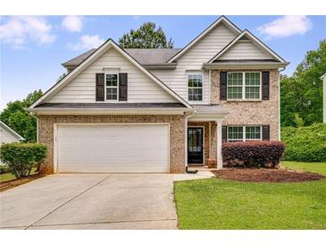 Charming two-story home featuring a brick facade, attached two-car garage and well-maintained lawn at 10204 Deep Creek Pl, Union City, GA 30291