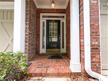 Charming brick home featuring a classic front door with sidelights and a welcoming entryway at 2656 Gadsen Walk, Duluth, GA 30097