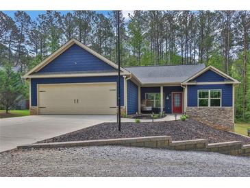 Charming blue craftsman-style home with a two-car garage and a well-manicured front yard at 154 Carmen Ln, Dallas, GA 30157