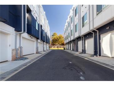 A view of the townhome garages, which are located on a shared driveway in a residential community at 1606 Rock Dam Dr # 11, Atlanta, GA 30317