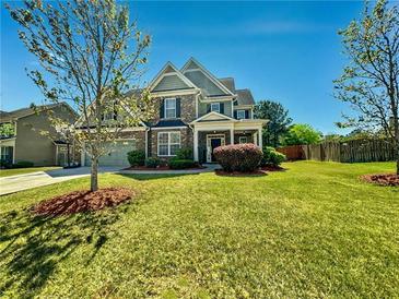 Charming two-story home with well-manicured lawn and lush landscaping at 5015 Scuppernong Ct, Austell, GA 30106