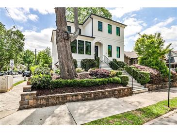 Charming two-story home featuring manicured landscaping and a welcoming entrance with black trim windows at 797 Greenwood Ne Ave, Atlanta, GA 30306