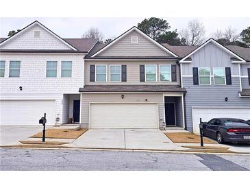 Charming townhome with a two-car garage and neutral-colored siding at 3401 Endurance Ct # 10, Atlanta, GA 30349