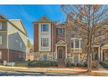 Brick and stone townhome with manicured landscaping and inviting front entrance at 3901 High Dove Sw Way # 17, Smyrna, GA 30082