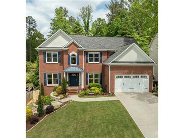 Beautiful two-story brick home with a manicured lawn and an attached two-car garage at 1657 Millhouse Lndg, Marietta, GA 30066