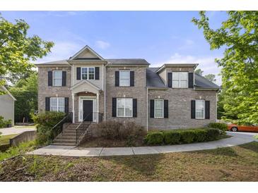 Charming brick home with well-maintained landscaping and a welcoming entrance at 4914 Brown Leaf Dr, Powder Springs, GA 30127