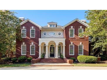 Stately brick home with an elegant entrance featuring a columned portico and manicured landscaping at 1477 Highway 85 Connector, Brooks, GA 30205