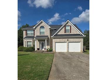 Charming two-story brick home with a two-car garage and well-manicured lawn at 5130 Hopewell Manor Dr, Cumming, GA 30028