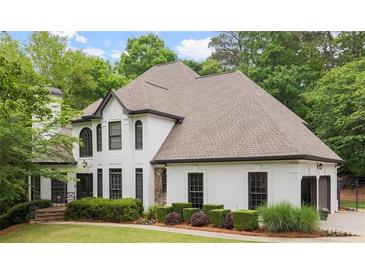 Charming two-story home with a manicured lawn and beautiful landscaping at 725 Danbridge Way, Roswell, GA 30076