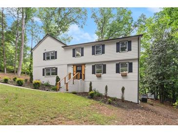 Charming two-story home featuring a white painted brick foundation and a welcoming front yard at 800 Breckinridge Sw Rd, Marietta, GA 30064