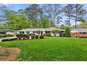 Charming ranch home with a well-manicured lawn, tidy hedges, and inviting curb appeal at 1155 Moores Mill Nw Rd, Atlanta, GA 30327
