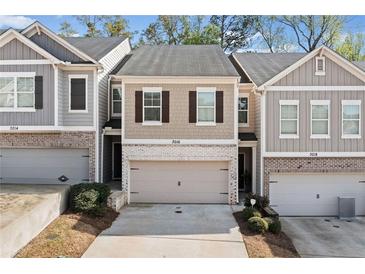 Charming townhome featuring a two-car garage and classic shutters at 3016 Creekside Overlook Way, Austell, GA 30168