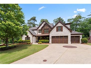 Charming home with stone accents, complemented by a well-manicured lawn and a spacious driveway at 2265 Venture Dr, Marietta, GA 30062