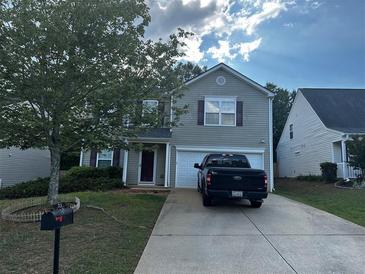 Two-story home with a driveway and a black truck parked in front of the garage at 314 Meadows Ln, Canton, GA 30114