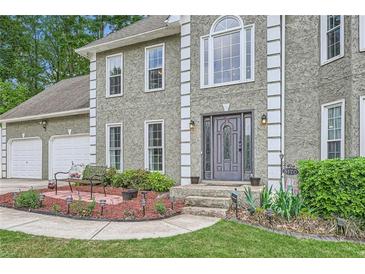 Charming two-story home with a well-manicured lawn, inviting entrance, and attached two car garage at 5170 Ridge Tarn, Acworth, GA 30102