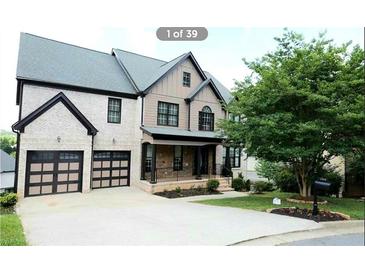 Beautiful two-story home with a manicured lawn and a two-car garage at 3306 Chastain Ridge Dr, Marietta, GA 30066