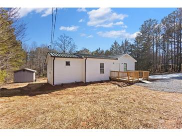 Charming home featuring a deck and wheelchair ramp, set amongst mature trees in a private setting at 4064 Post Rd, Winston, GA 30187