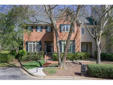 Charming brick home with manicured landscaping, lush greenery, and inviting curb appeal at 45 Paces West Nw Dr, Atlanta, GA 30327
