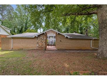 Brick exterior with stone detail and gated entry exudes curb appeal at 4701 Riverwood Cir, Decatur, GA 30035