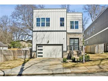 Modern two-story home showcasing a white exterior, garage, and well-maintained front yard at 2020 Bixby Se St, Atlanta, GA 30317