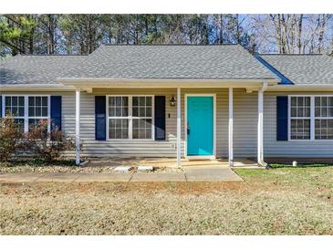 Charming home featuring a vibrant turquoise front door and classic navy shutters at 447 Wallace Way, Rockmart, GA 30153
