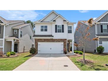 Charming two-story home featuring a two-car garage and a well-maintained front yard at 118 Woodhouse Cir, Acworth, GA 30102