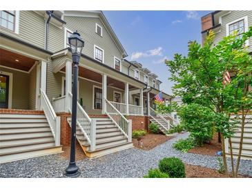 Charming townhomes feature covered porches and landscaped walkways for a welcoming curb appeal at 1076 Green St, Roswell, GA 30075