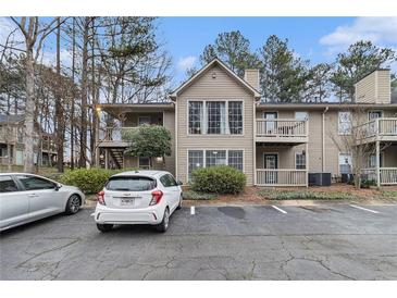 Exterior of condo featuring two stories, a small balcony, and well-maintained landscaping at 2002 Country Park Se Dr, Smyrna, GA 30080