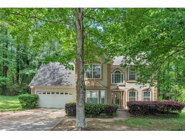 Charming two-story home with attached garage and mature landscaping at 745 Birchberry Sw Ter, Atlanta, GA 30331