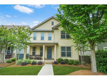 Charming two-story home with a well-manicured lawn, front porch seating, and beautiful landscaping at 3219 Colchester St, Douglasville, GA 30135