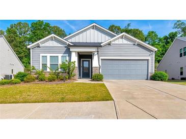 Charming single-Gathering home with manicured lawn, gray siding, and attached two-car garage at 316 Denali Butte Ter, Canton, GA 30114