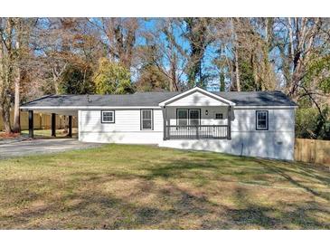Charming one-story home featuring white siding, a cozy front porch, and a convenient carport at 1766 Blossom Ln, Austell, GA 30168