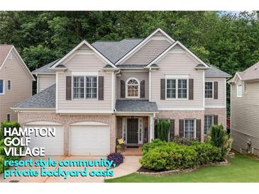 Charming two-story home featuring a brick-and-siding facade, manicured landscaping, and a welcoming two-car garage at 5415 Old Haven Ct, Cumming, GA 30041