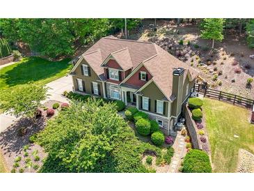 Aerial view of a two-story home featuring manicured landscaping and a well-maintained lawn at 112 Pebblebrooke Run, Canton, GA 30115
