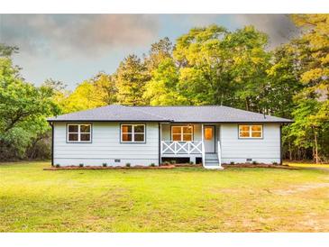 Charming single story home with a welcoming front porch and a well maintained lawn with mature landscaping at 4665 Jersey Walnut Grove Rd, Covington, GA 30014